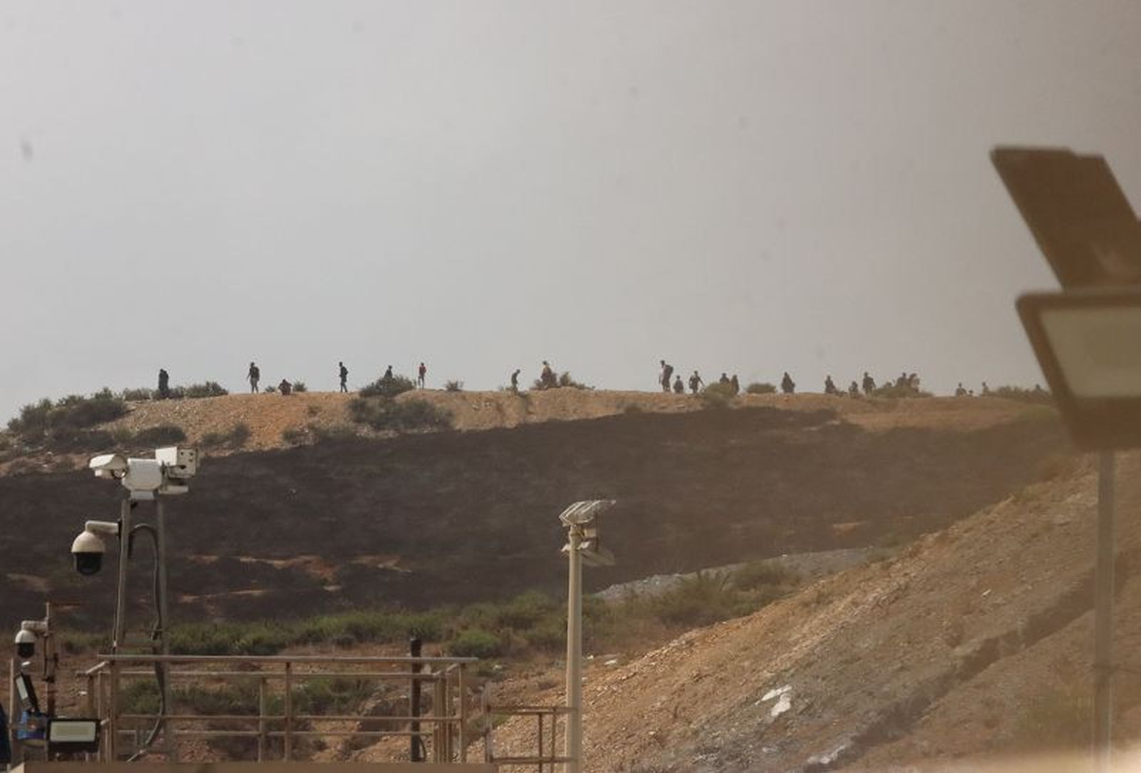 Tomada desde territorio español, se observa la hilera de personas en territorio marroquí que esperaba saltar la valla, este pasado domingo 15 de septiembre. / FOTO REDUAN