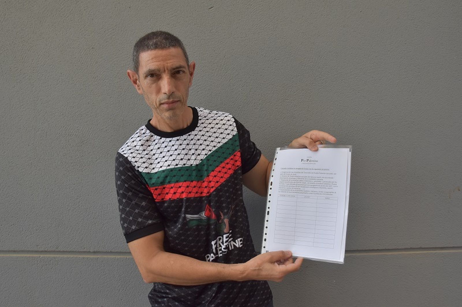 El médico del HUCE Abdeselam Buyema posa mostrando la hoja de firmas para la iniciativa "Por una Palestina Viva". / FOTO G.S.