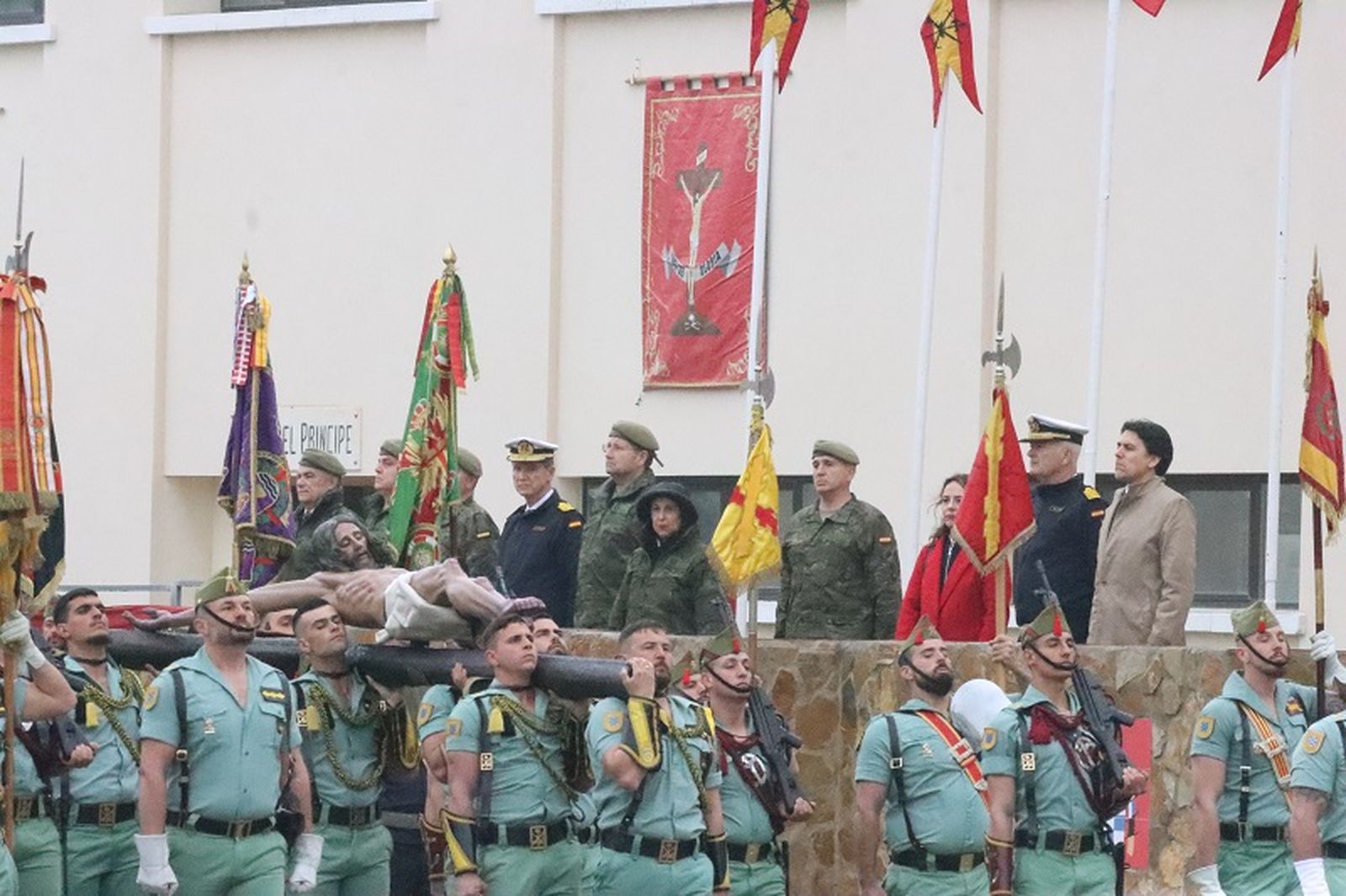 La ministra de Defensa observa al Cristo de la Buena Muerte llevado por legionarios de Ceuta, junto al comandante general, Marcos Llago. / FOTO REDUAN